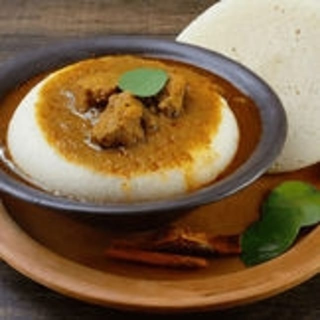 Idli with Mutton Kulambu (Gravy).