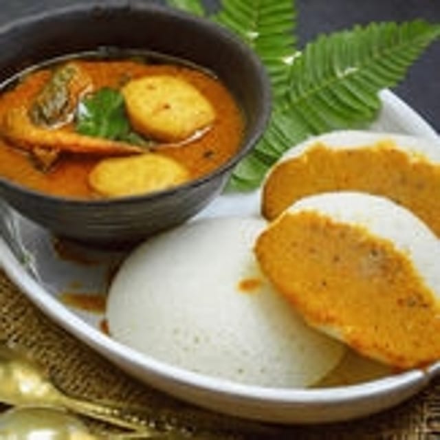 Idli with Fish Kulambu (Gravy).